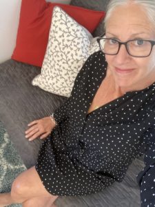 nancy wears a black polkadot housedress