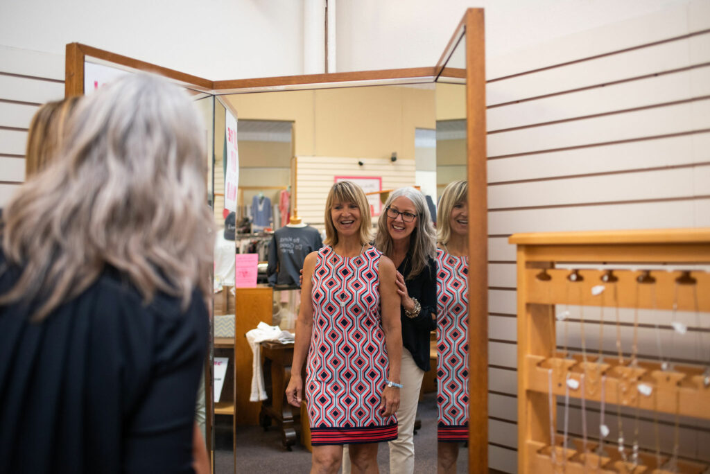 Nancy dilts with client in front of a mirror. 